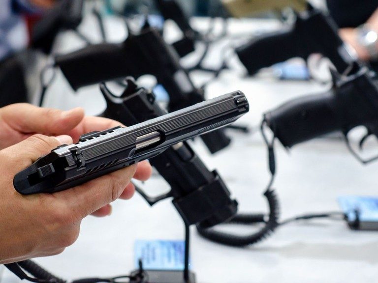 A hands-on look at a pistol during a consultation